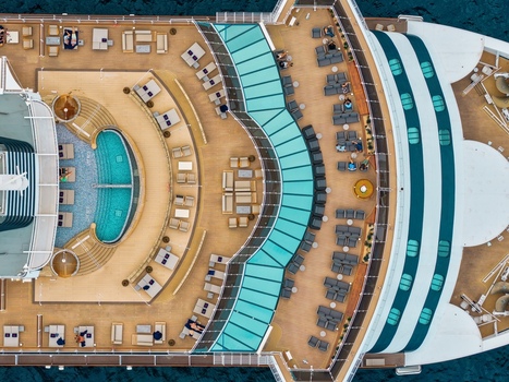 Aerial view of a cruise ship deck with a swimming pool lounge chairs and guests relaxing on the wooden deck in Cannes Provence Alpes Cote d Azur France. Aerial view of a cruise ship deck with a swimming pool lounge chairs and guests relaxing on the wooden deck in Cannes Provence Alpes Cote d Azur France.
