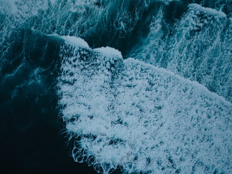 Aerial view of crashing waves with white foam and deep blue water at La Jolla Cove San Diego California United States. Aerial view of crashing waves with white foam and deep blue water at La Jolla Cove San Diego California United States.
