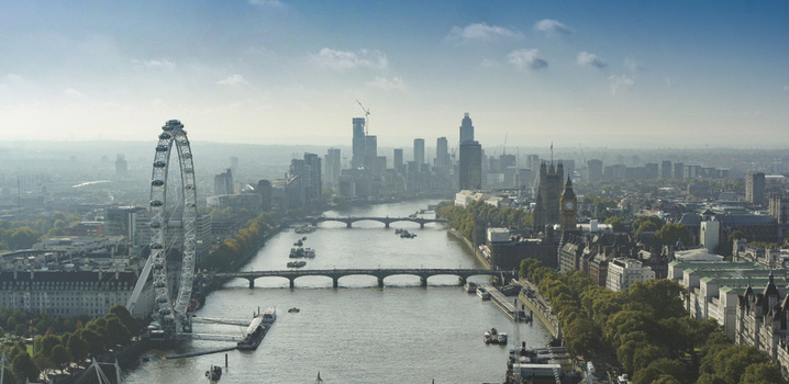 Aerial view of the London Eye and Big Ben along the River Thames with the city skyline and bridges in London England United Kingdom.