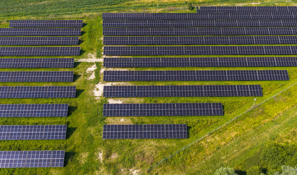 Aerial view of rows of solar panels installed in a green field in Gdansk Pomeranian Voivodeshi Poland.