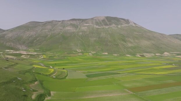 Aerial view of Castelluccio plain with colorful fields Italy.
