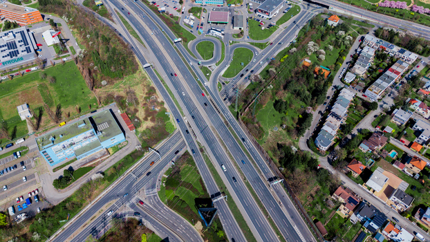 Aerial view of a bustling highway intersection cutting through green spaces and buildings a symphony of concrete and nature Prague Prague Czechia. Aerial view of a bustling highway intersection cutting through green spaces and buildings a symphony of concrete and nature Prague Prague Czechia.