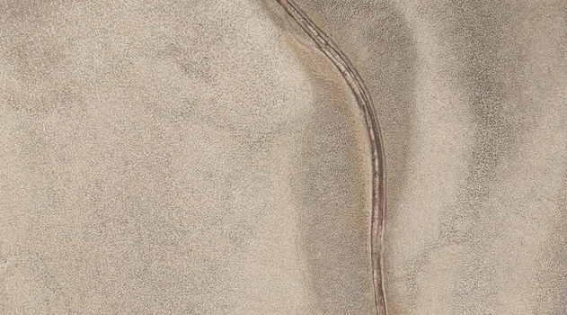 Aerial view of a dry riverbed cutting through the parched arid landscape of the North West province highlighting the effects of drought in Bloemhof North West South Africa. Aerial view of a dry riverbed cutting through the parched arid landscape of the North West province highlighting the effects of drought in Bloemhof North West South Africa.