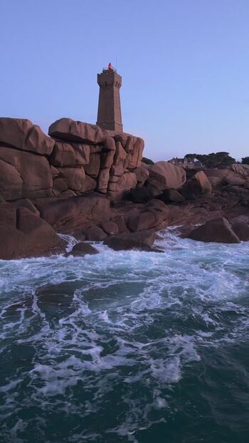 Aerial view of Phare de Men Ruz on pink granite rocks France.
