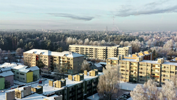 Aerial view of residential apartment blocks surrounded by snow covered trees and a forest in winter Latvija. Aerial view of residential apartment blocks surrounded by snow covered trees and a forest in winter Latvija.