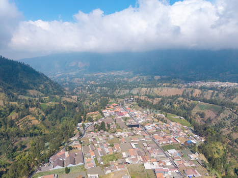 Aerial view of Wonokerto village nestled in the mountainous landscape of Sukorejo East Java Indonesia. Aerial view of Wonokerto village nestled in the mountainous landscape of Sukorejo East Java Indonesia.