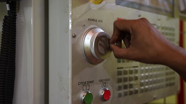 View of a hand operating a CNC machine control panel Bangladesh.