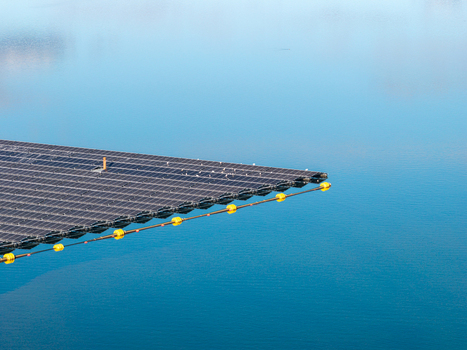 Aerial view of the floating solar system on Cottbuser Ostsee featuring dark photovoltaic panels on calm blue water with yellow buoys at a former mine in Cottbus Brandenburg Germany. Aerial view of the floating solar system on Cottbuser Ostsee featuring dark photovoltaic panels on calm blue water with yellow buoys at a former mine in Cottbus Brandenburg Germany.