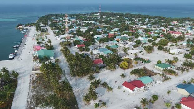 Aerial view of coastal village and palm trees Maldives. Aerial view of coastal village and palm trees Maldives.