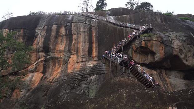 View of tourists climbing the stairs of Sigiriya Rock Sri Lanka.