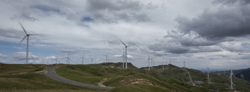 View of Harapaki Wind Farm with wind turbines on rolling green hills under a cloudy sky in Te Haroto Hawke s Bay Region New Zealand. View of Harapaki Wind Farm with wind turbines on rolling green hills under a cloudy sky in Te Haroto Hawke s Bay Region New Zealand.