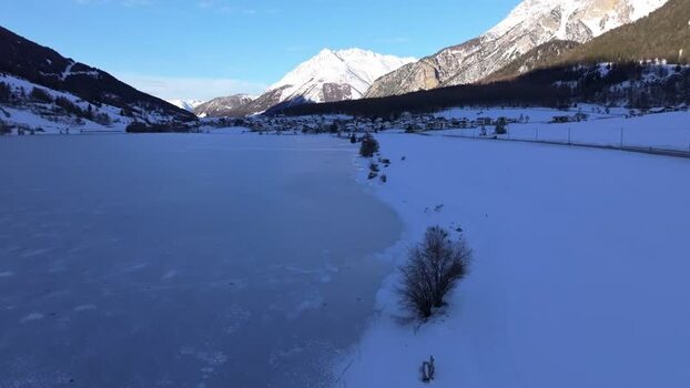 Aerial view of Graun im Vinschgau frozen lake in Italy. Aerial view of Graun im Vinschgau frozen lake in Italy.