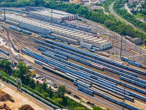 Aerial view of a large train depot with multiple passenger trains parked on parallel tracks next to industrial buildings in Prague Prague Czechia.