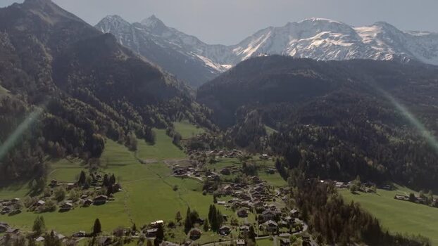 FPV aerial view of a mountain village in the French Alps France.