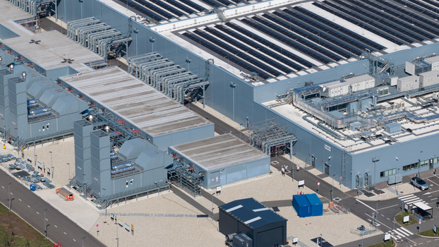 Aerial view of the HGB industrial facility featuring large factory buildings with solar panels ventilation systems and surrounding paved areas in Winschoten Groningen Netherlands.