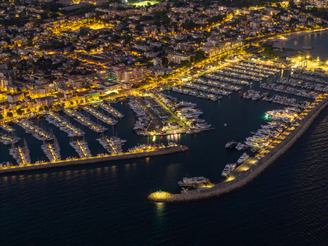Aerial view of Port Vauban marina at night with illuminated yachts docks and the coastal city lights of Antibes Provence Alpes Cote d Azur France. Aerial view of Port Vauban marina at night with illuminated yachts docks and the coastal city lights of Antibes Provence Alpes Cote d Azur France.