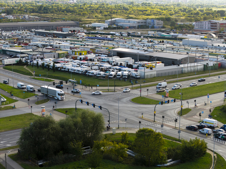 Krakow Poland 16 September 2026 Aerial view of Farmer s Market Rybitwy with rows of parked delivery trucks and vans surrounding industrial buildings and a busy intersection in the foreground. Krakow Poland 16 September 2026 Aerial view of Farmer s Market Rybitwy with rows of parked delivery trucks and vans surrounding industrial buildings and a busy intersection in the foreground.