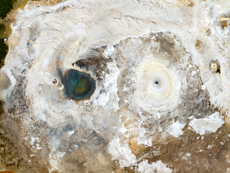 Aerial view of Hveravellir geothermal area with vibrant mineral deposits and steaming hot springs in Hunabyggd Iceland.