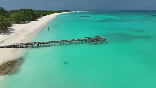 Aerial view of a wooden pier on a turquoise tropical beach Maldives. Aerial view of a wooden pier on a turquoise tropical beach Maldives.