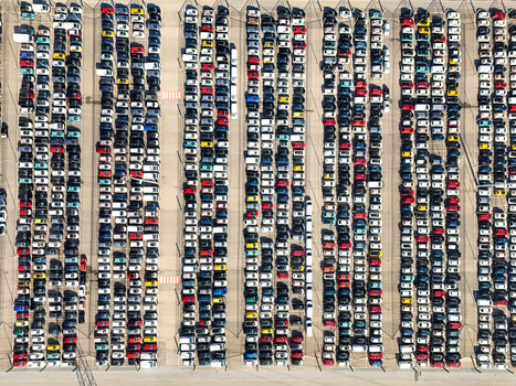 Aerial view of a vast parking lot filled with rows of multi colored cars parked in neat lines at an industrial facility in Rivalta di Torino Piedmont Italy. Aerial view of a vast parking lot filled with rows of multi colored cars parked in neat lines at an industrial facility in Rivalta di Torino Piedmont Italy.