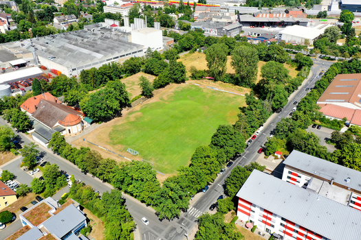 Aerial view of the SpVgg Jahn Forchheim Jugendabteilung sports field surrounded by lush green trees and urban buildings in Forchheim Bayern Germany. Aerial view of the SpVgg Jahn Forchheim Jugendabteilung sports field surrounded by lush green trees and urban buildings in Forchheim Bayern Germany.