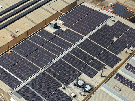 Aerial view of solar panels installed on the roof of a large industrial factory building with ventilation units and metal roofing Kilsyth Victoria Australia. Aerial view of solar panels installed on the roof of a large industrial factory building with ventilation units and metal roofing Kilsyth Victoria Australia.
