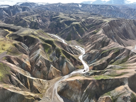 Aerial view of Landmannalaugar featuring colorful rhyolite mountains winding glacial rivers and rugged volcanic terrain in Hella Rangarthing ytra Iceland. Aerial view of Landmannalaugar featuring colorful rhyolite mountains winding glacial rivers and rugged volcanic terrain in Hella Rangarthing ytra Iceland.