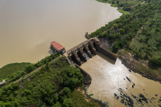 Aerial view of the Asejire Dam its concrete structure stark against the muddy water and vibrant green vegetation Asejire Oyo Nigeria. Aerial view of the Asejire Dam its concrete structure stark against the muddy water and vibrant green vegetation Asejire Oyo Nigeria.