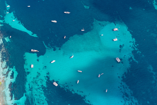 Aerial view of boats anchored in the clear turquoise waters surrounding Ile Sainte Marguerite Cannes Provence Alpes Cote d Azur France. Aerial view of boats anchored in the clear turquoise waters surrounding Ile Sainte Marguerite Cannes Provence Alpes Cote d Azur France.