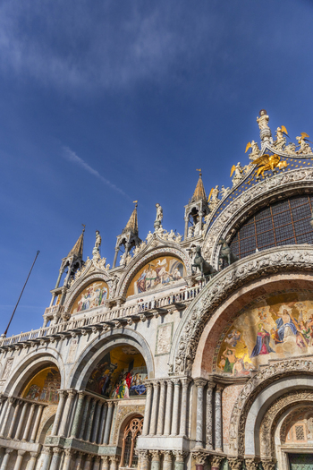 Venice Veneto Italy 21 September 2026 View of the ornate facade of St. Mark s Basilica featuring intricate mosaics marble columns and golden statues under a clear blue sky. Venice Veneto Italy 21 September 2026 View of the ornate facade of St. Mark s Basilica featuring intricate mosaics marble columns and golden statues under a clear blue sky.