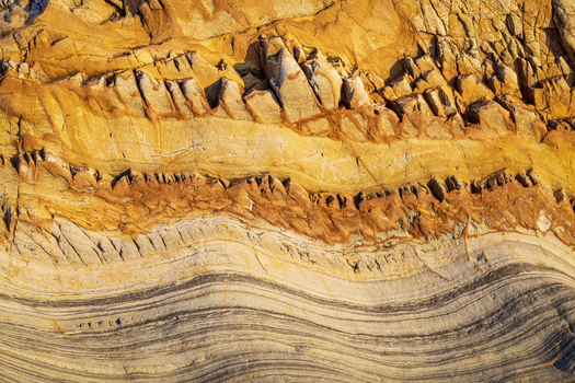 View of the unique geological rock formations and layered sedimentary textures at Silence Beach in Asturias Asturias Spain.