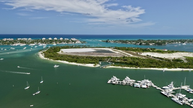 Aerial view of Peanut Island featuring lush tropical vegetation white sand beaches and luxury yachts docked in the turquoise waters of the Lake Worth Lagoon Palm Beach County Florida United States.