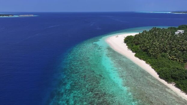 Aerial view of Kamadhoo island beach and coral reef Maldives. Aerial view of Kamadhoo island beach and coral reef Maldives.