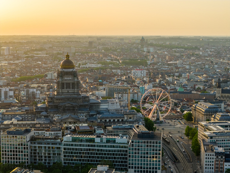 Aerial view of the Palace of Justice with its iconic dome a Ferris wheel and the surrounding urban skyline during golden hour in Brussels Brussels Belgium. Aerial view of the Palace of Justice with its iconic dome a Ferris wheel and the surrounding urban skyline during golden hour in Brussels Brussels Belgium.