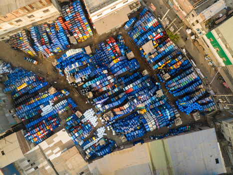 Aerial view of thousands of colorful plastic barrels stacked in an outdoor industrial storage yard in Dhaka Dhaka Division Bangladesh. Aerial view of thousands of colorful plastic barrels stacked in an outdoor industrial storage yard in Dhaka Dhaka Division Bangladesh.