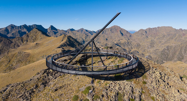 Aerial view of the Tristaina Sundial Balcony a circular viewing platform atop a mountain peak surrounded by the rugged rocky landscape of the Pyrenees in Ordino Ordino Andorra.