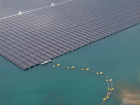 Aerial view of a floating solar farm with rows of photovoltaic panels on calm water in the Netherlands. Aerial view of a floating solar farm with rows of photovoltaic panels on calm water in the Netherlands.