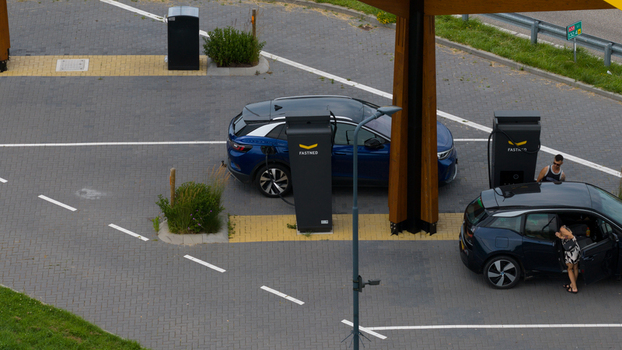 Krabbendijke Netherlands 28 June 2026 Aerial view of electric vehicles charging at a Fastned station with modern charging pillars and paved parking area. Krabbendijke Netherlands 28 June 2026 Aerial view of electric vehicles charging at a Fastned station with modern charging pillars and paved parking area.