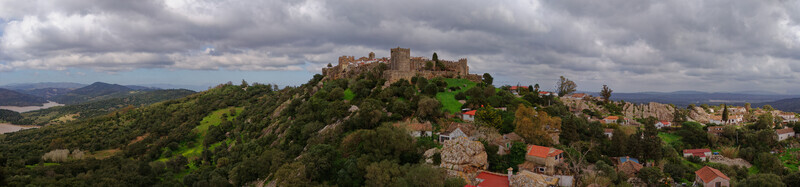 Aerial view of the Castillo de Castellar stands proudly atop a hill its stone walls a stark contrast to the lush green landscape Castellar de la Frontera Andalusia Spain. Aerial view of the Castillo de Castellar stands proudly atop a hill its stone walls a stark contrast to the lush green landscape Castellar de la Frontera Andalusia Spain.