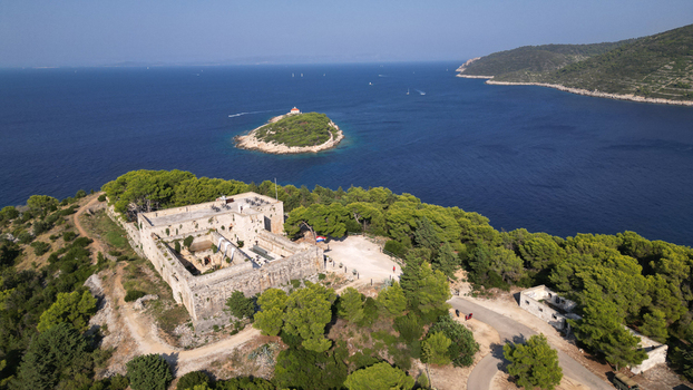 Aerial view of Fort George with its historic stone walls surrounded by lush pine trees overlooking the Adriatic Sea and Host Island Vis Splitsko dalmatinska Croatia. Aerial view of Fort George with its historic stone walls surrounded by lush pine trees overlooking the Adriatic Sea and Host Island Vis Splitsko dalmatinska Croatia.