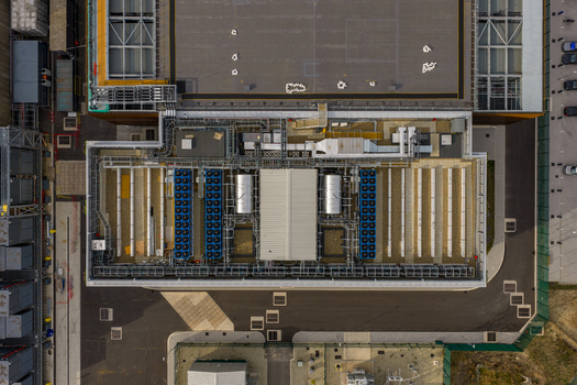 Aerial view of Ark Data Centres at Longcross Park featuring industrial rooftop cooling units and complex HVAC infrastructure in Chertsey England United Kingdom. Aerial view of Ark Data Centres at Longcross Park featuring industrial rooftop cooling units and complex HVAC infrastructure in Chertsey England United Kingdom.