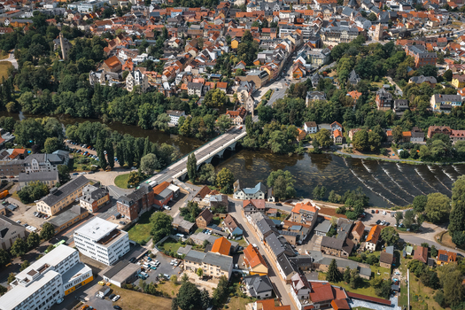 Aerial view of the historic town of Saalfeld featuring the river Saale and a stone bridge in Saalfeld Thuringia Germany. Aerial view of the historic town of Saalfeld featuring the river Saale and a stone bridge in Saalfeld Thuringia Germany.