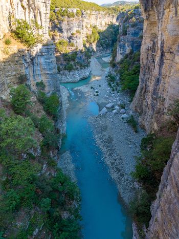 Aerial view of Osumi Canyon with its steep limestone cliffs turquoise river water and lush green vegetation in Dhores Berat County Albania.