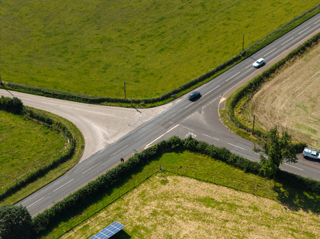 Aerial view of Lisburn Solar Farm surrounded by green fields and a road intersection with cars in Lisburn Northern Ireland United Kingdom. Aerial view of Lisburn Solar Farm surrounded by green fields and a road intersection with cars in Lisburn Northern Ireland United Kingdom.