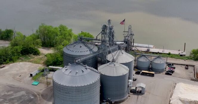 Aerial view of industrial grain silos by the river United States. Aerial view of industrial grain silos by the river United States.