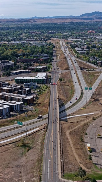 Aerial view of a highway and surrounding urban landscape with modern buildings and green spaces in Boulder Colorado United States. Aerial view of a highway and surrounding urban landscape with modern buildings and green spaces in Boulder Colorado United States.