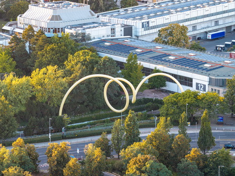 Aerial view of the Looping sculpture by Ursula Sax situated amidst lush green trees and modern exhibition hall buildings in Berlin Berlin Germany. Aerial view of the Looping sculpture by Ursula Sax situated amidst lush green trees and modern exhibition hall buildings in Berlin Berlin Germany.