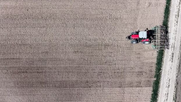 Aerial view of tractor plowing field France.
