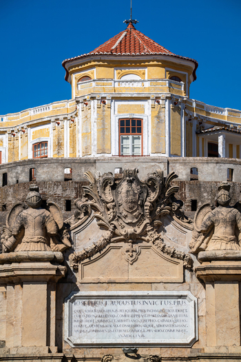 Elvas Portugal 10 September 2026 View of the ornate stone facade and coat of arms at the entrance of the historic Forte de Nossa Senhora da Graca with yellow walls and red tiled roof. Elvas Portugal 10 September 2026 View of the ornate stone facade and coat of arms at the entrance of the historic Forte de Nossa Senhora da Graca with yellow walls and red tiled roof.