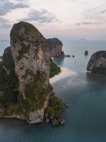 Aerial view of rugged cliffs meet the tranquil turquoise sea a serene paradise unfolds from above Krabi Thailand. Aerial view of rugged cliffs meet the tranquil turquoise sea a serene paradise unfolds from above Krabi Thailand.